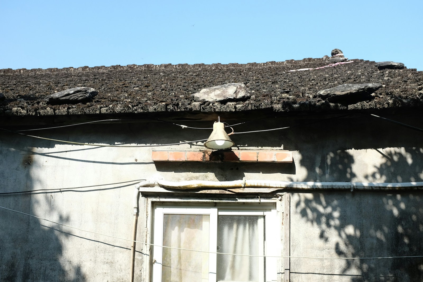 a building with a roof that has a clock on it